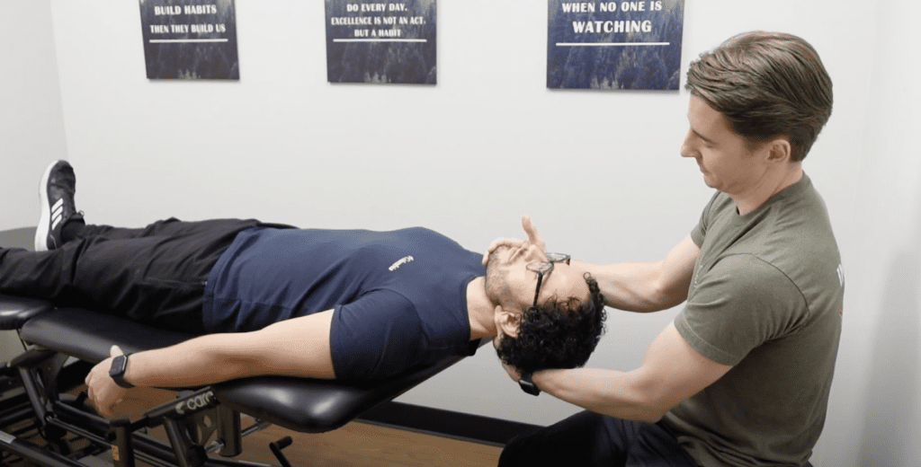 Brian Greer, physical therapist and certified McKenzie Method diplmoat, assessing neck pain of male patient