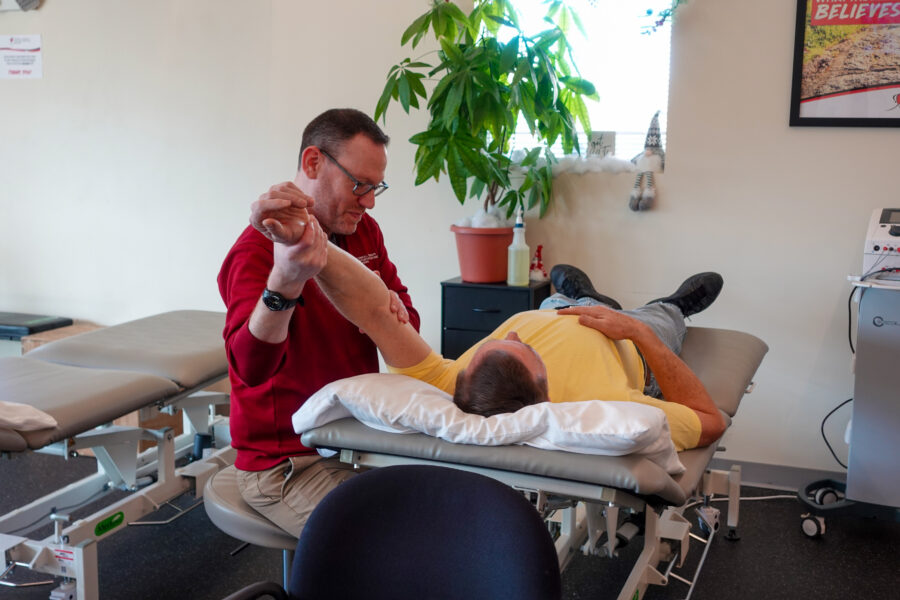 Middletown Physical Therapist helping male patient with arm exercise