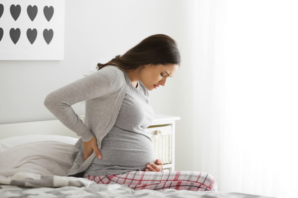 pregnant woman feeling pain in bedroom