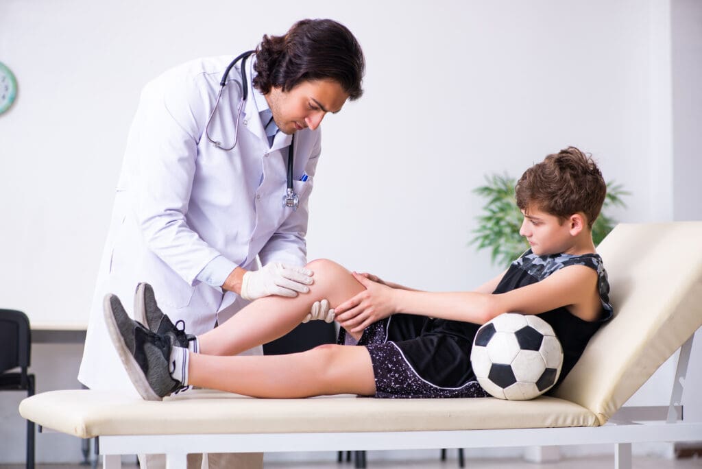 Young male athlete visiting doctor for new injury