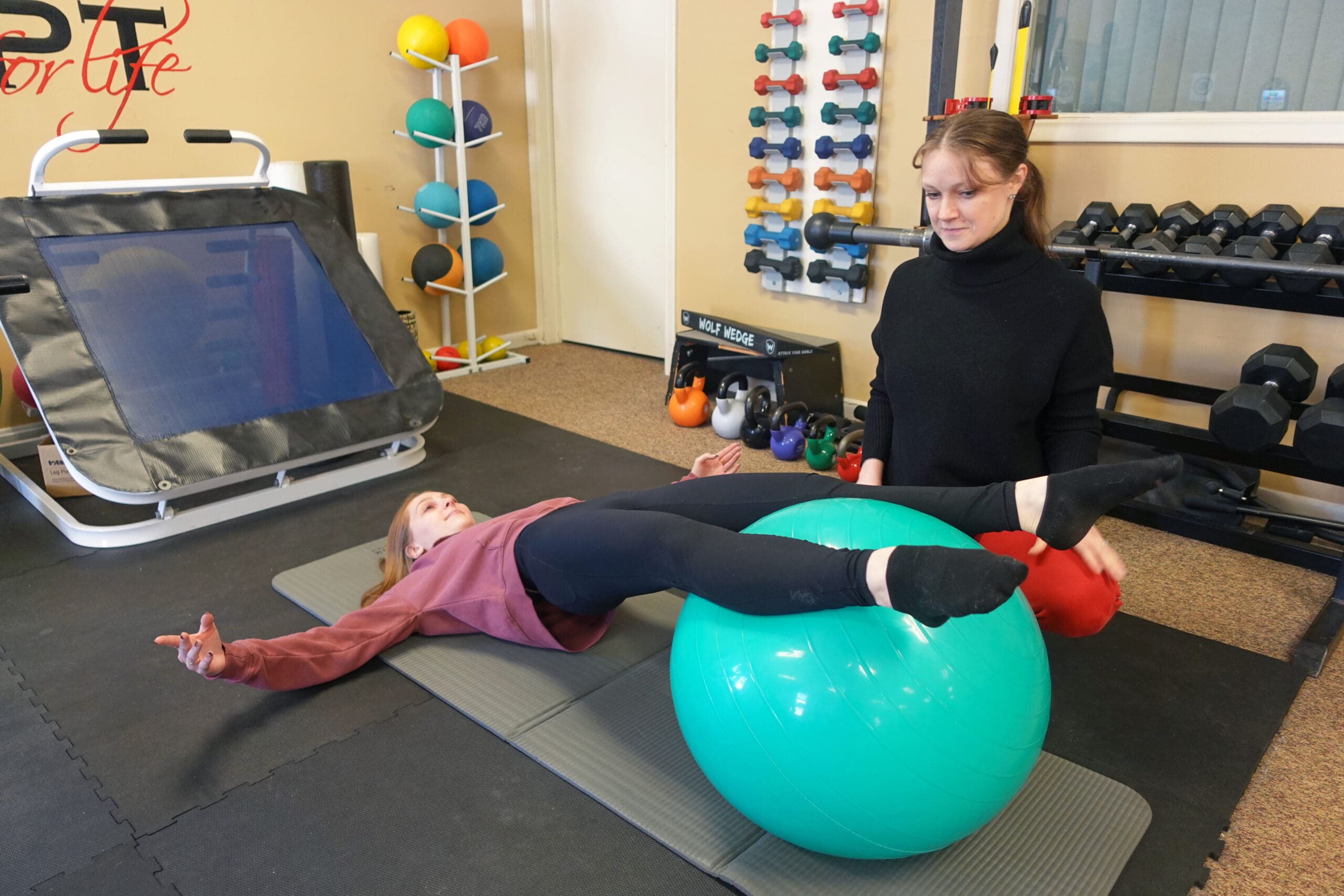 Physical Therapy & Sports Medicine Centers (PTSMC) Southington. Brianne Dwyer, female physical therapist, treating a female dancer using an exercise ball